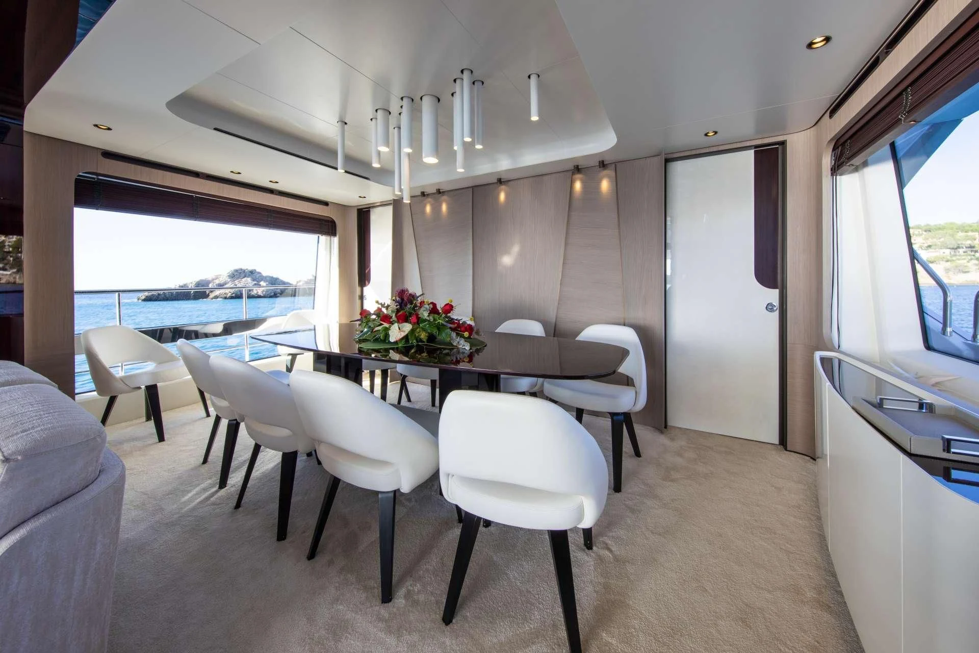 a room with a table and chairs aboard CLOUDY BAY Yacht for Sale