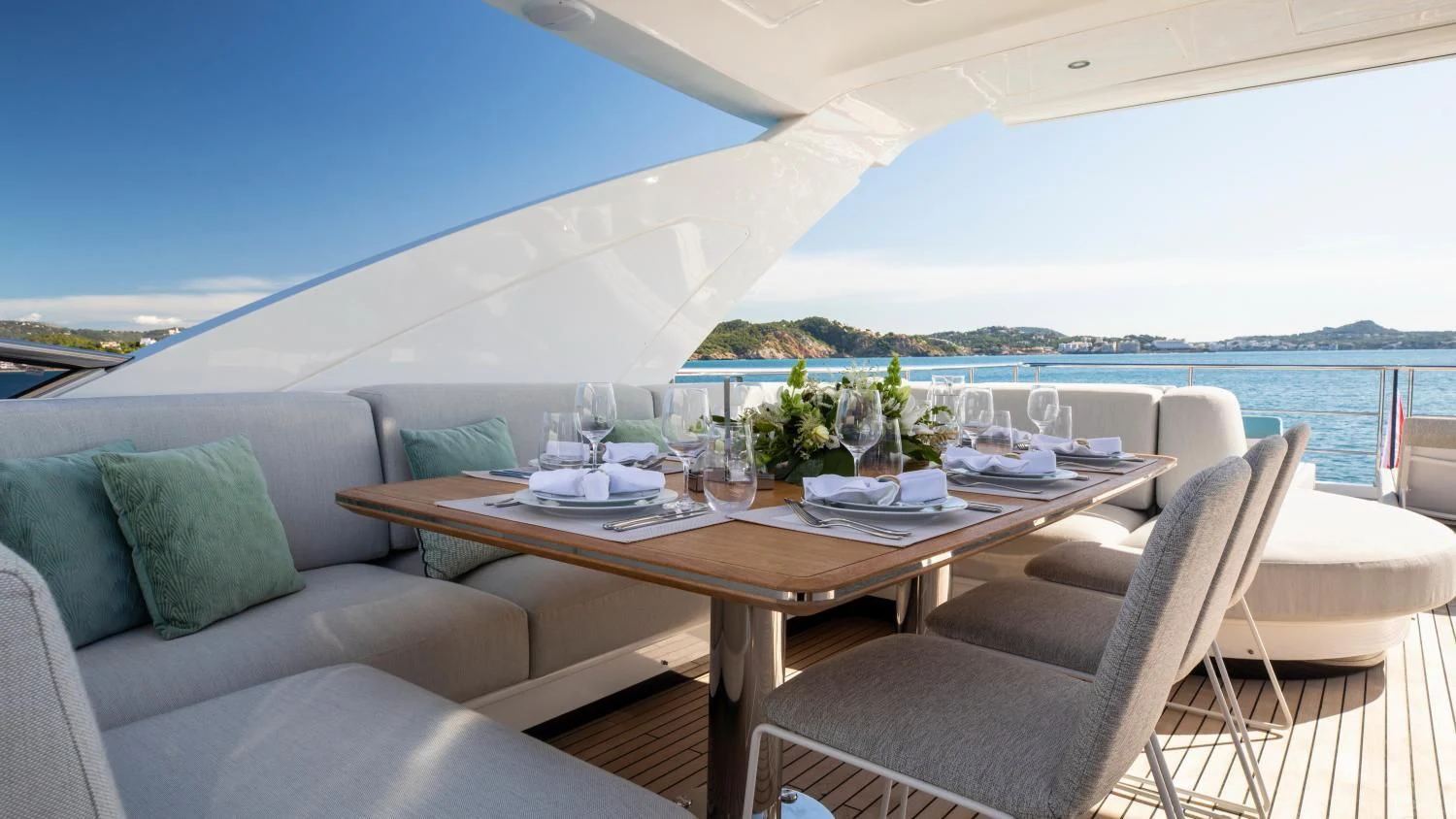 a table and chairs on a patio aboard CLOUDY BAY Yacht for Sale