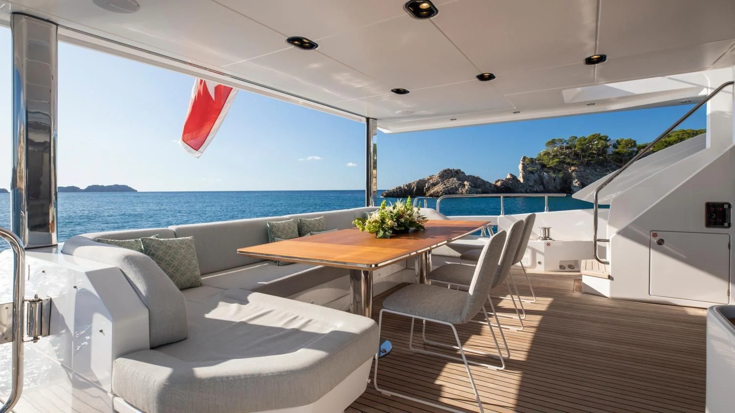 a room with a table and chairs aboard CLOUDY BAY Yacht for Sale