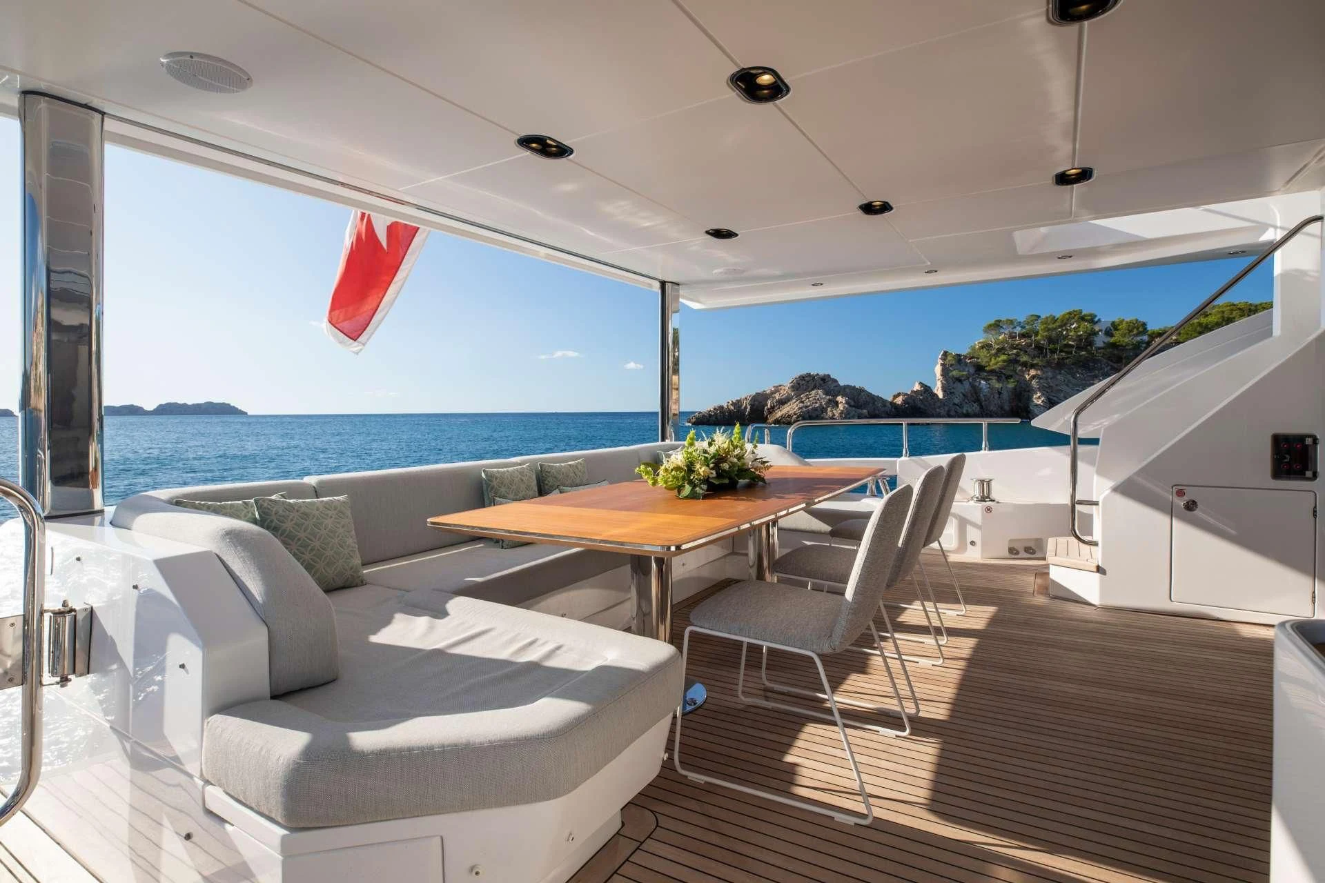 a room with a table and chairs aboard CLOUDY BAY Yacht for Sale