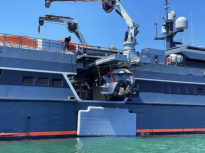 a large ship docked aboard HODOR Yacht for Charter