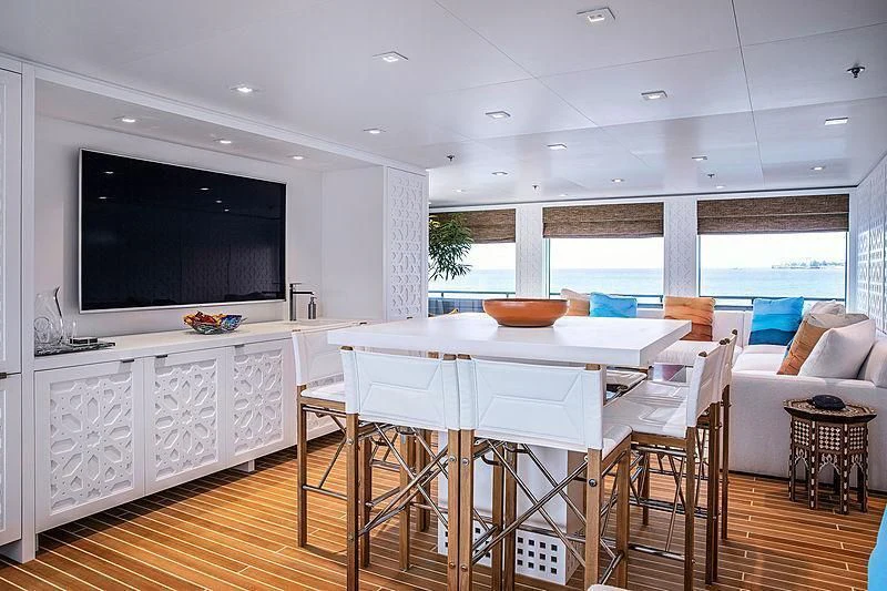 a room with a table and chairs aboard HODOR Yacht for Charter