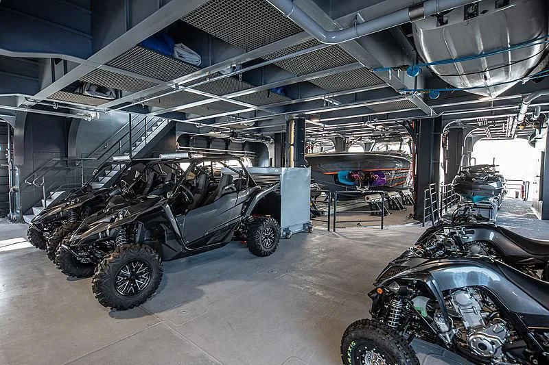 a group of military vehicles in a garage aboard HODOR Yacht for Charter
