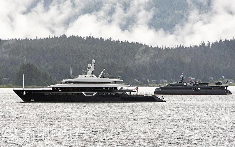 a large ship next to a smaller ship in the water aboard HODOR Yacht for Charter