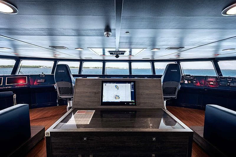 a room with a table and chairs aboard HODOR Yacht for Charter