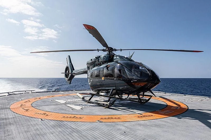 a helicopter landing on a deck aboard HODOR Yacht for Charter