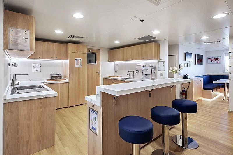 a kitchen with a wooden floor aboard HODOR Yacht for Charter