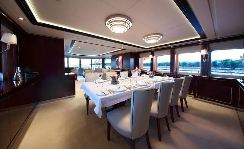 a restaurant with tables and chairs aboard AILISH V Yacht for Sale