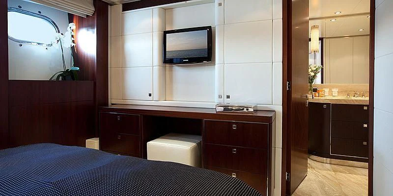 a room with a bed and a tv on the wall aboard AILISH V Yacht for Sale