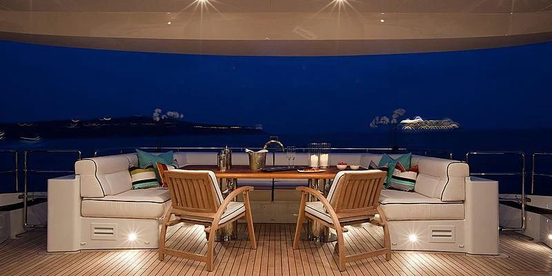 a room with a table chairs and a couch aboard AILISH V Yacht for Sale