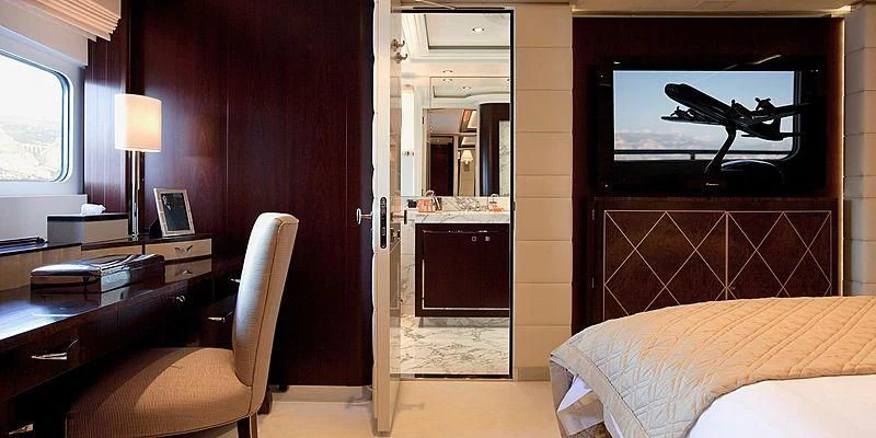 a bedroom with a bed and a desk aboard AILISH V Yacht for Sale