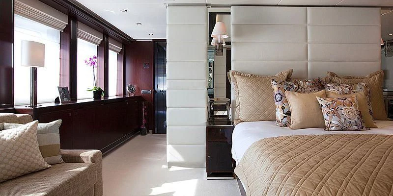 a bedroom with a bed and a desk aboard AILISH V Yacht for Sale