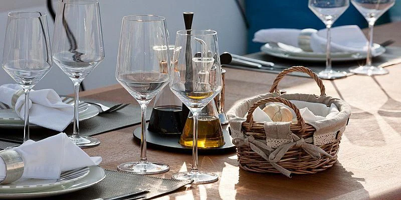 a table with wine glasses and food aboard AILISH V Yacht for Sale