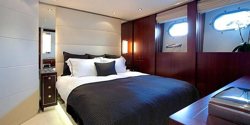 a room with a bed and a window aboard AILISH V Yacht for Sale
