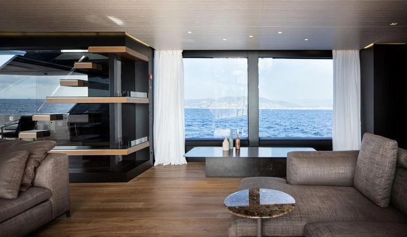 a living room with a large window aboard PIOLA Yacht for Sale
