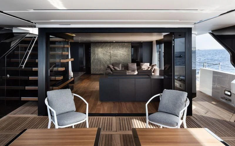 a room with a couch and a table and chairs aboard PIOLA Yacht for Sale