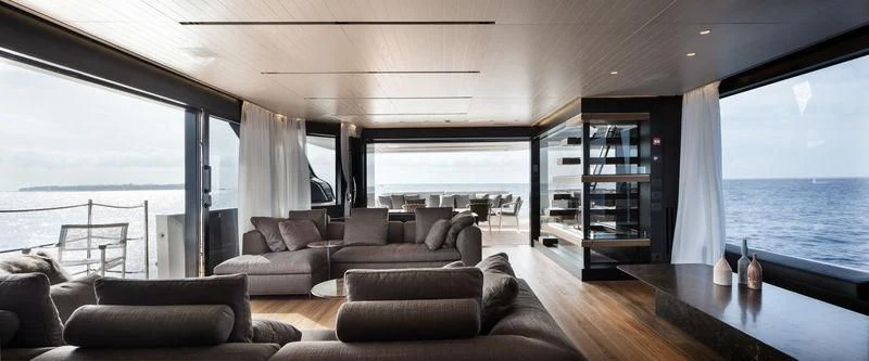 a living room with a large window aboard PIOLA Yacht for Sale