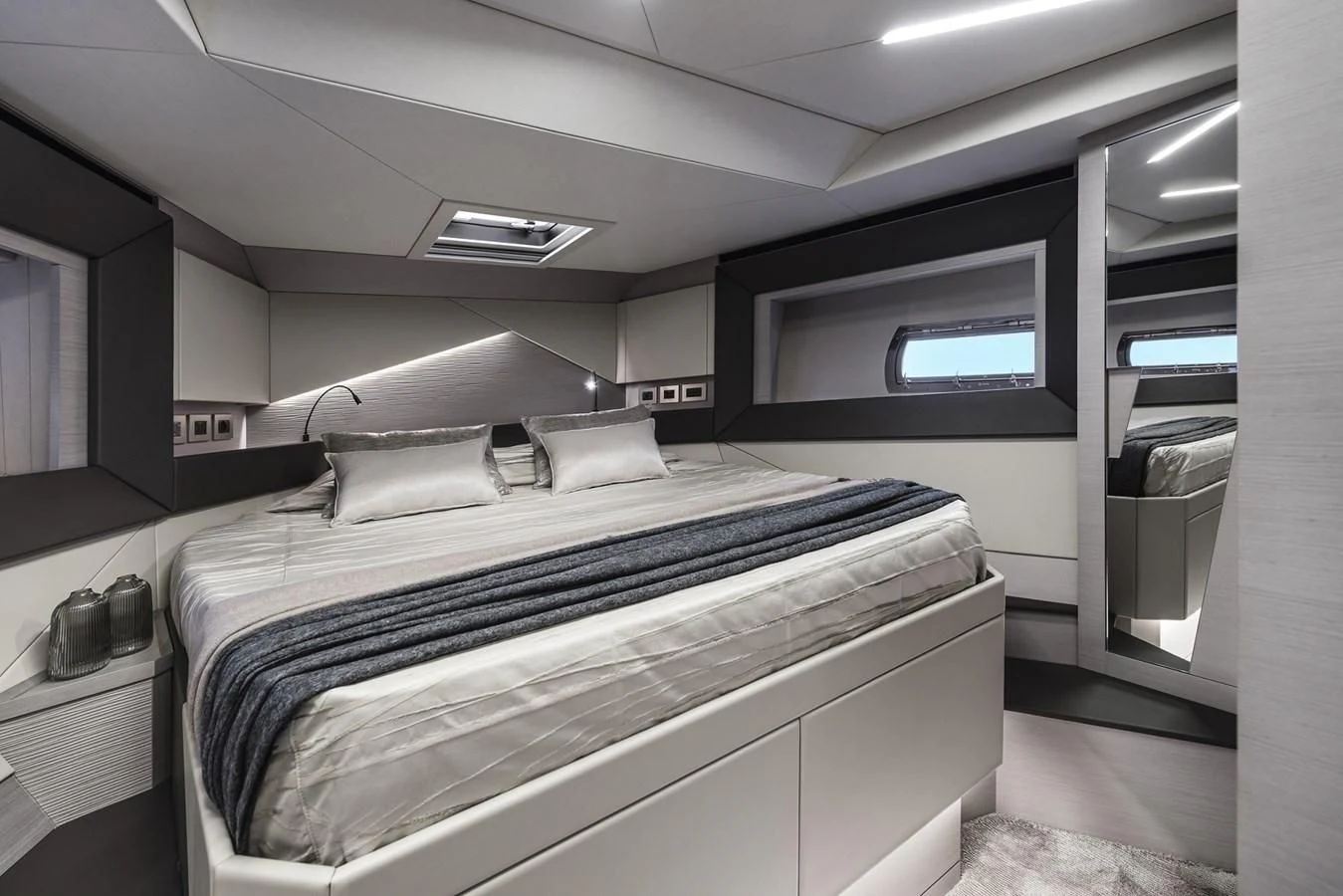 a room with a bed and a desk aboard PERSHING 7X Yacht for Sale