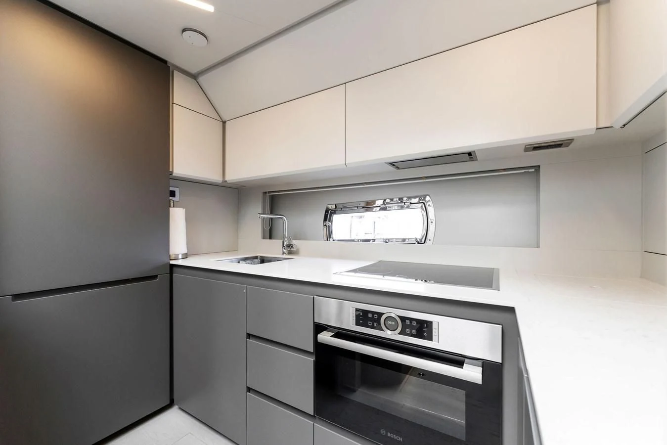 a kitchen with a stove and refrigerator aboard PERSHING 7X Yacht for Sale