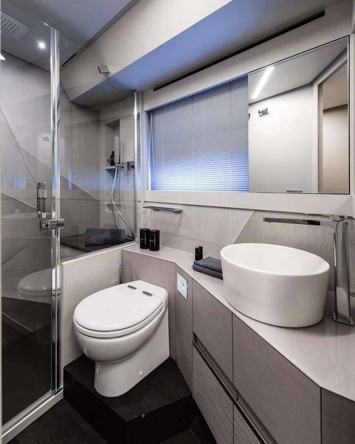 a bathroom with a glass shower aboard PERSHING 7X Yacht for Sale