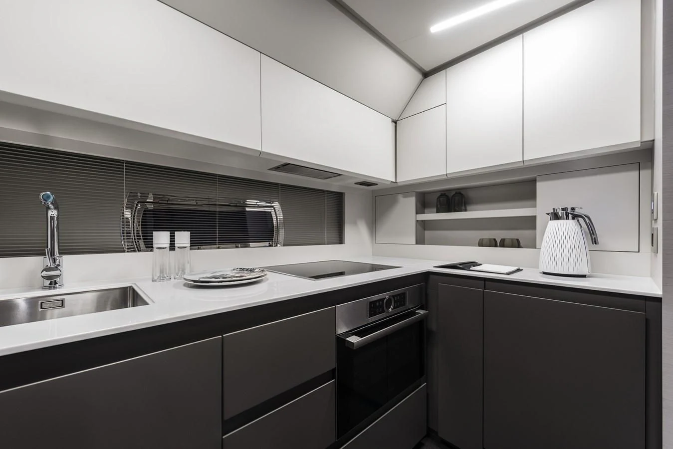 a kitchen with white cabinets aboard PERSHING 7X Yacht for Sale