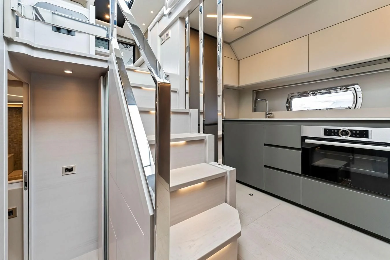 a kitchen with white cabinets aboard PERSHING 7X Yacht for Sale