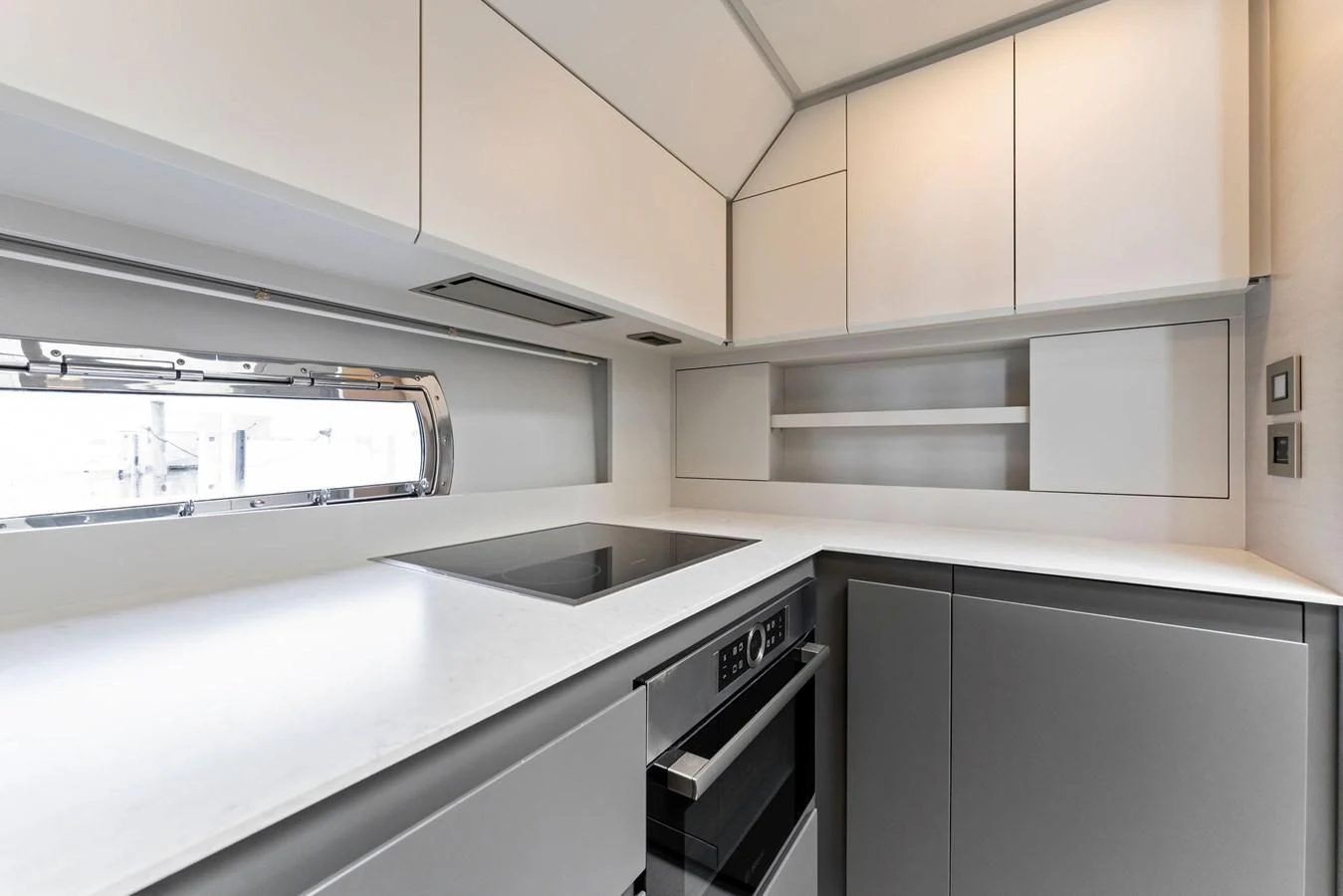 a kitchen with white cabinets aboard PERSHING 7X Yacht for Sale