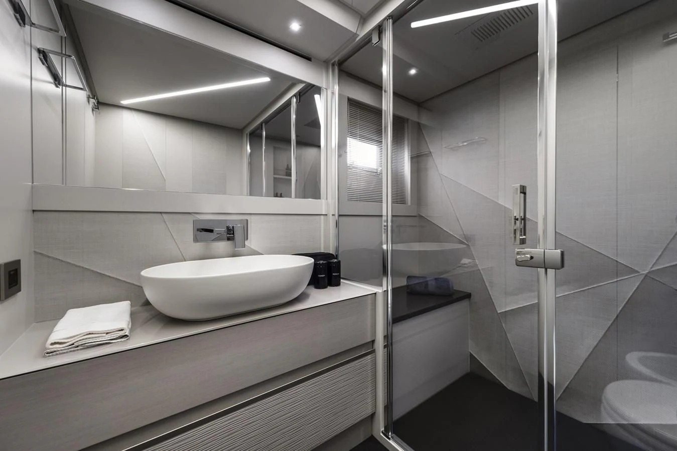 a bathroom with a sink and a mirror aboard PERSHING 7X Yacht for Sale