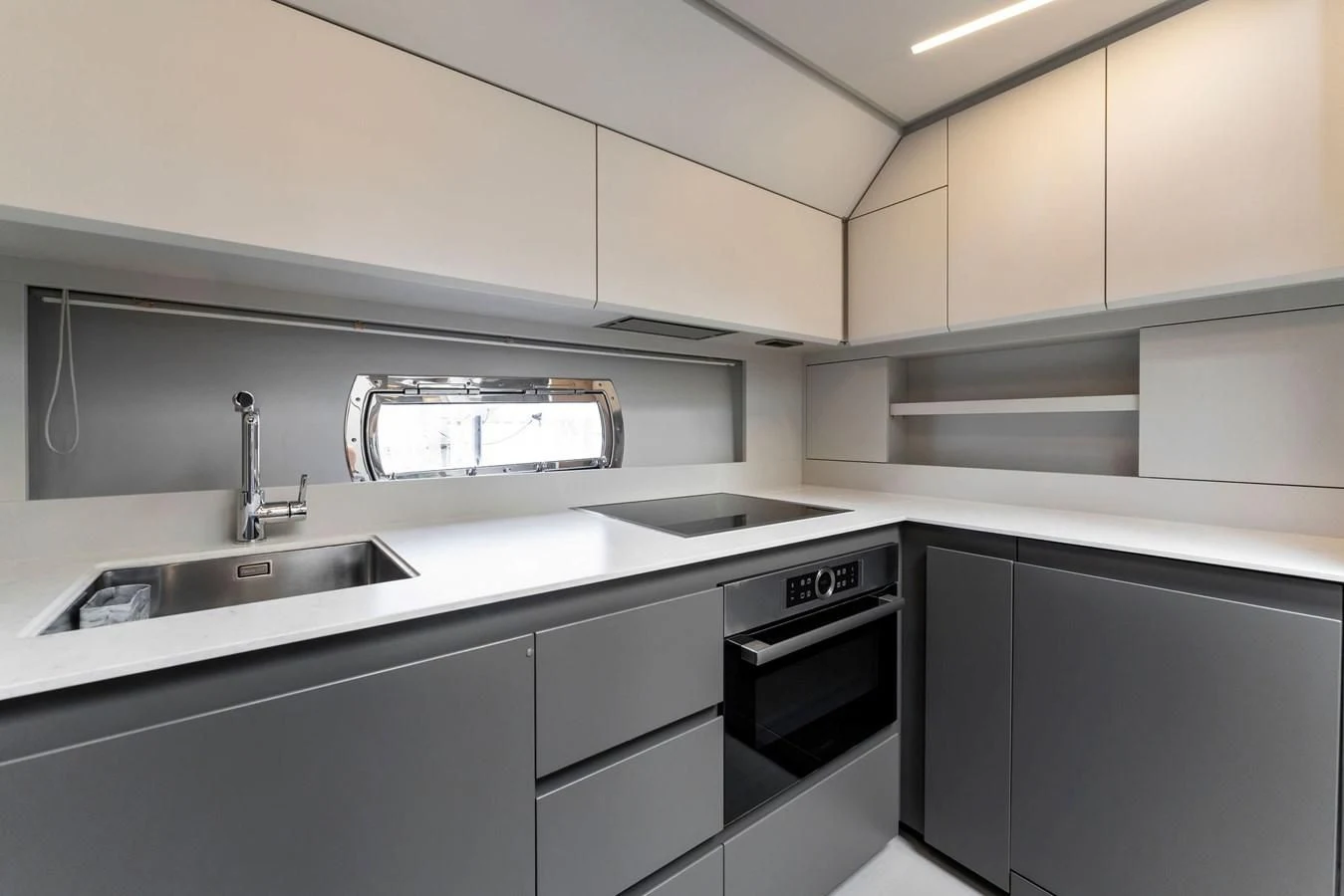 a kitchen with white cabinets aboard PERSHING 7X Yacht for Sale