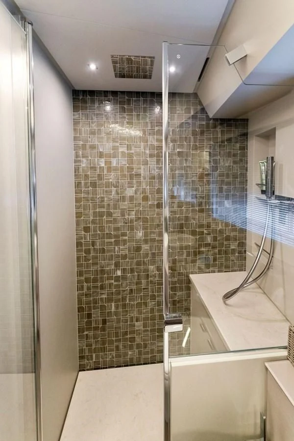a bathroom with a glass shower aboard PERSHING 7X Yacht for Sale