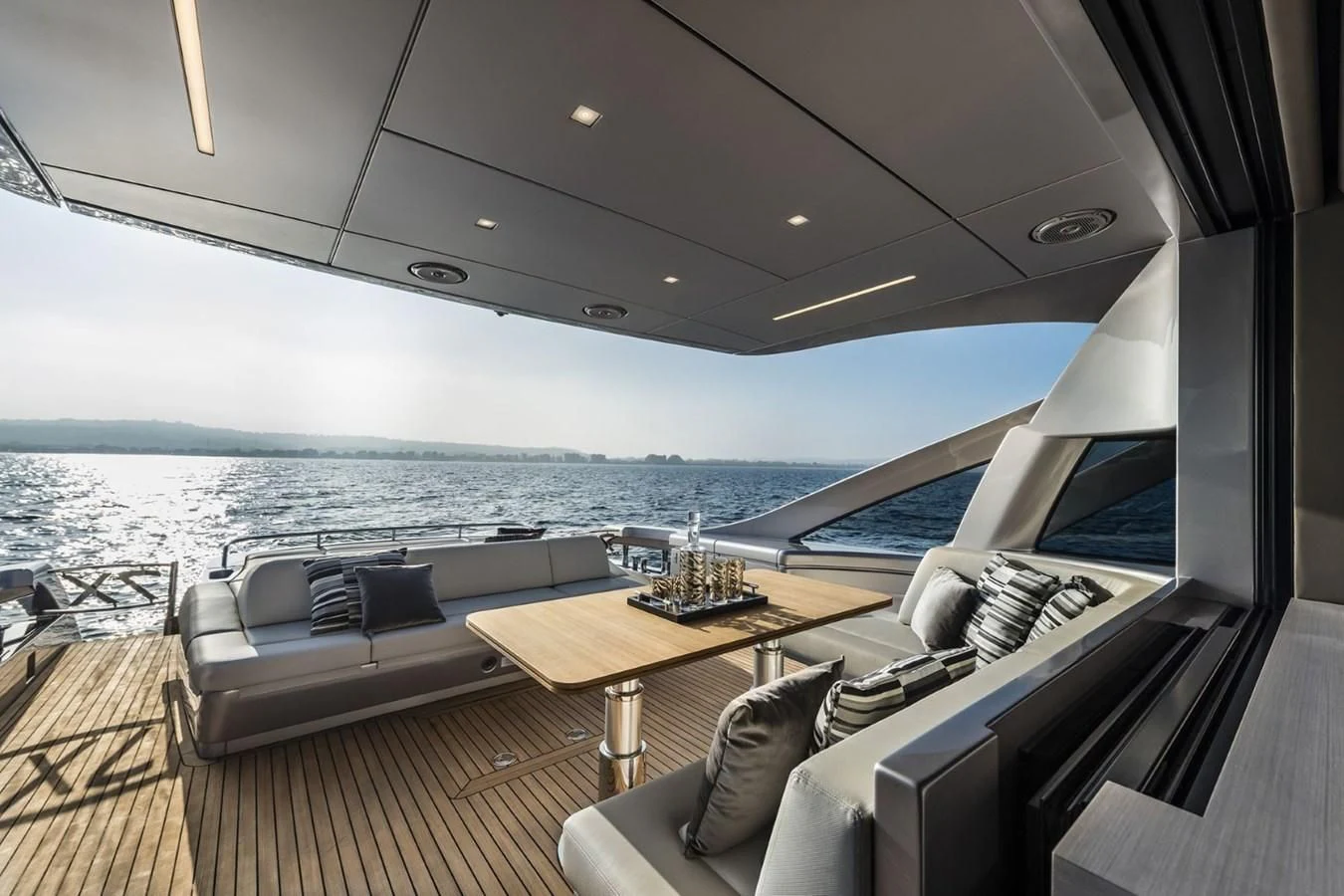 a boat with a table and chairs aboard PERSHING 7X Yacht for Sale