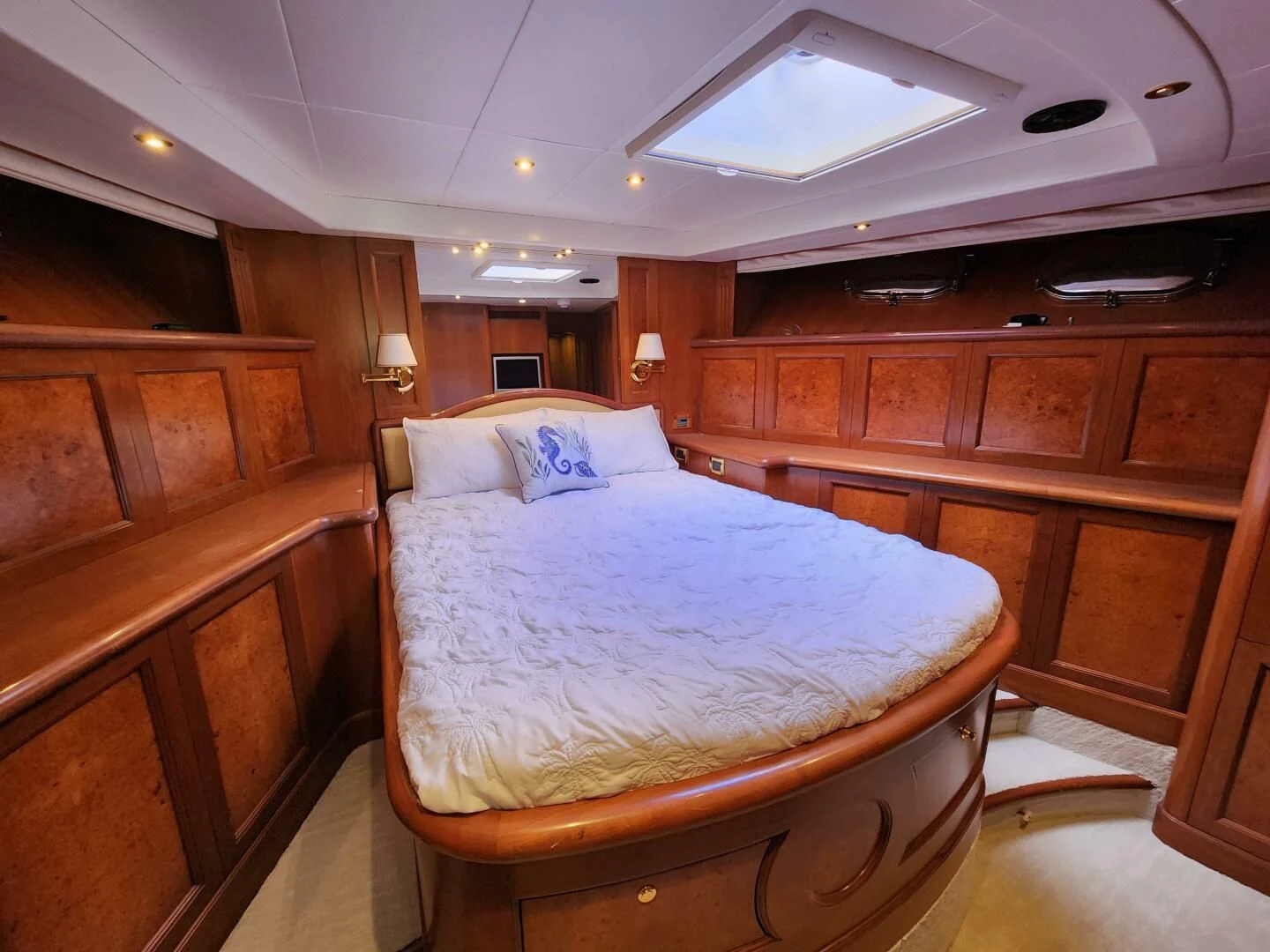 a bedroom with a bed and a wooden cabinet aboard BLUE SEAS Yacht for Sale