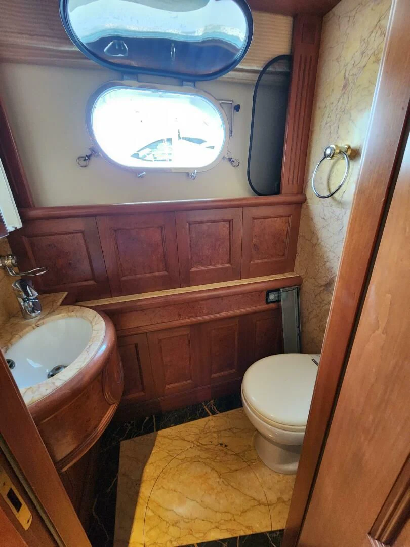 a bathroom with a round window aboard BLUE SEAS Yacht for Sale