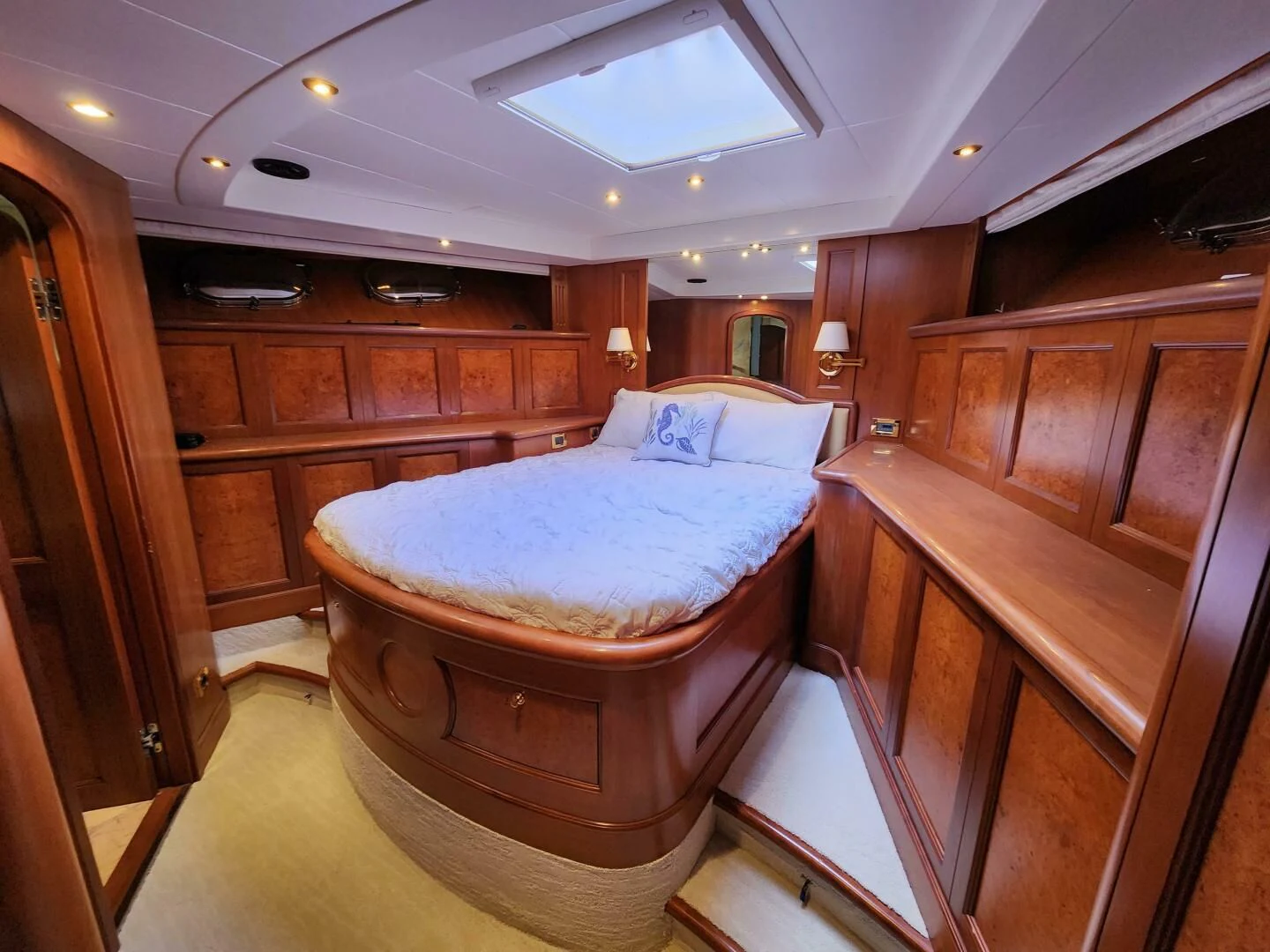 a bedroom with a bed and a wood cabinet aboard BLUE SEAS Yacht for Sale