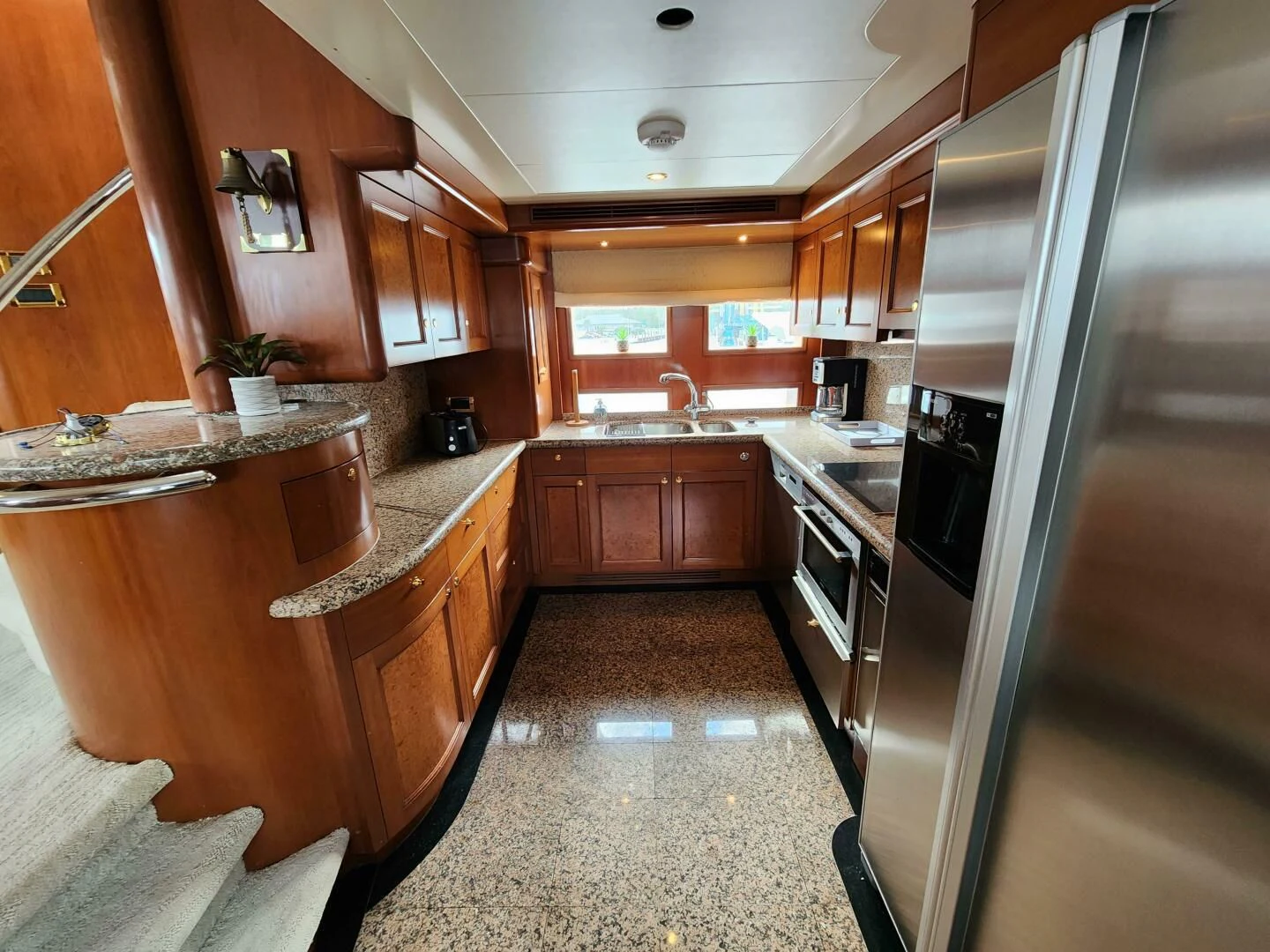 a kitchen with wooden cabinets aboard BLUE SEAS Yacht for Sale