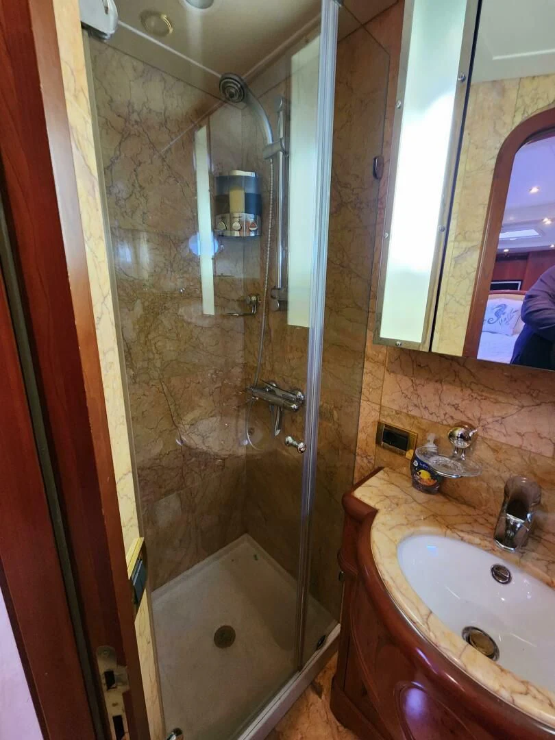 a bathroom with a glass shower aboard BLUE SEAS Yacht for Sale