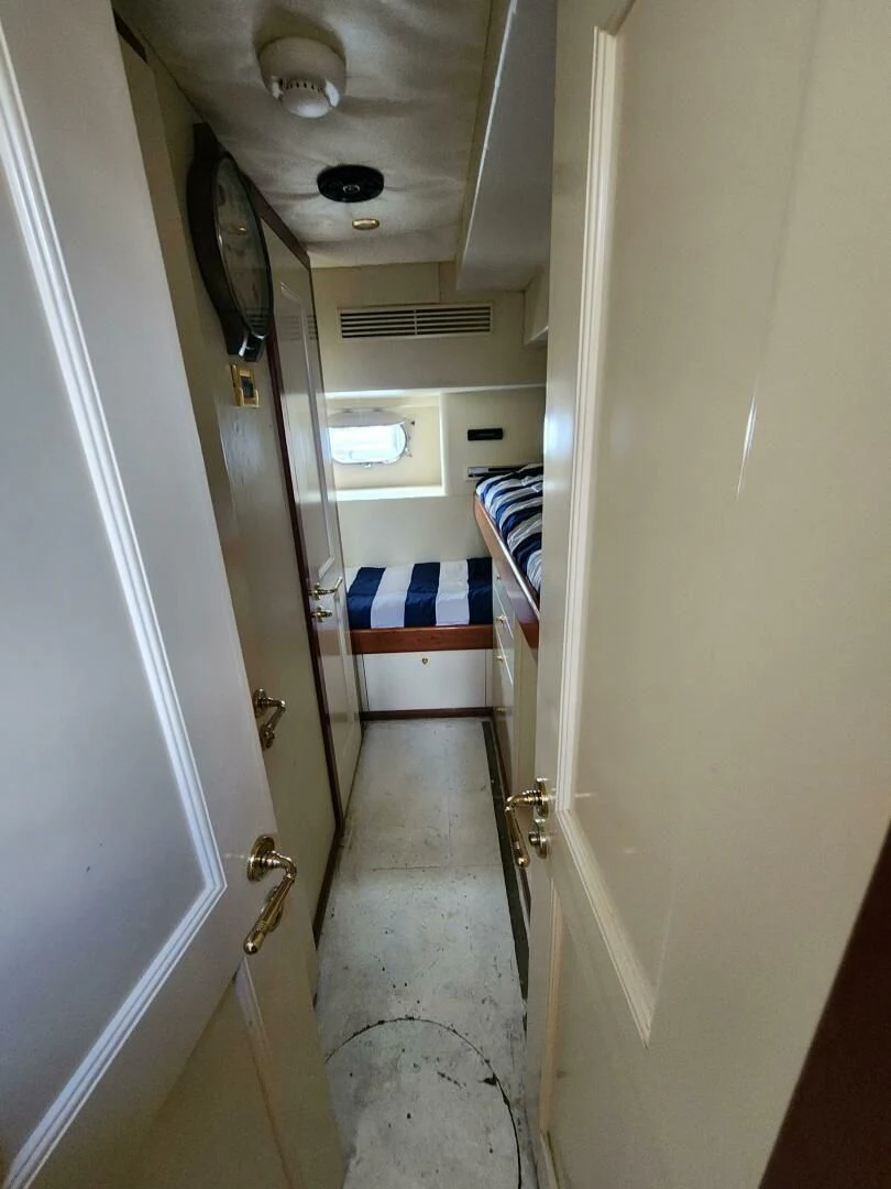a hallway with a blue and white striped floor and a white door aboard BLUE SEAS Yacht for Sale