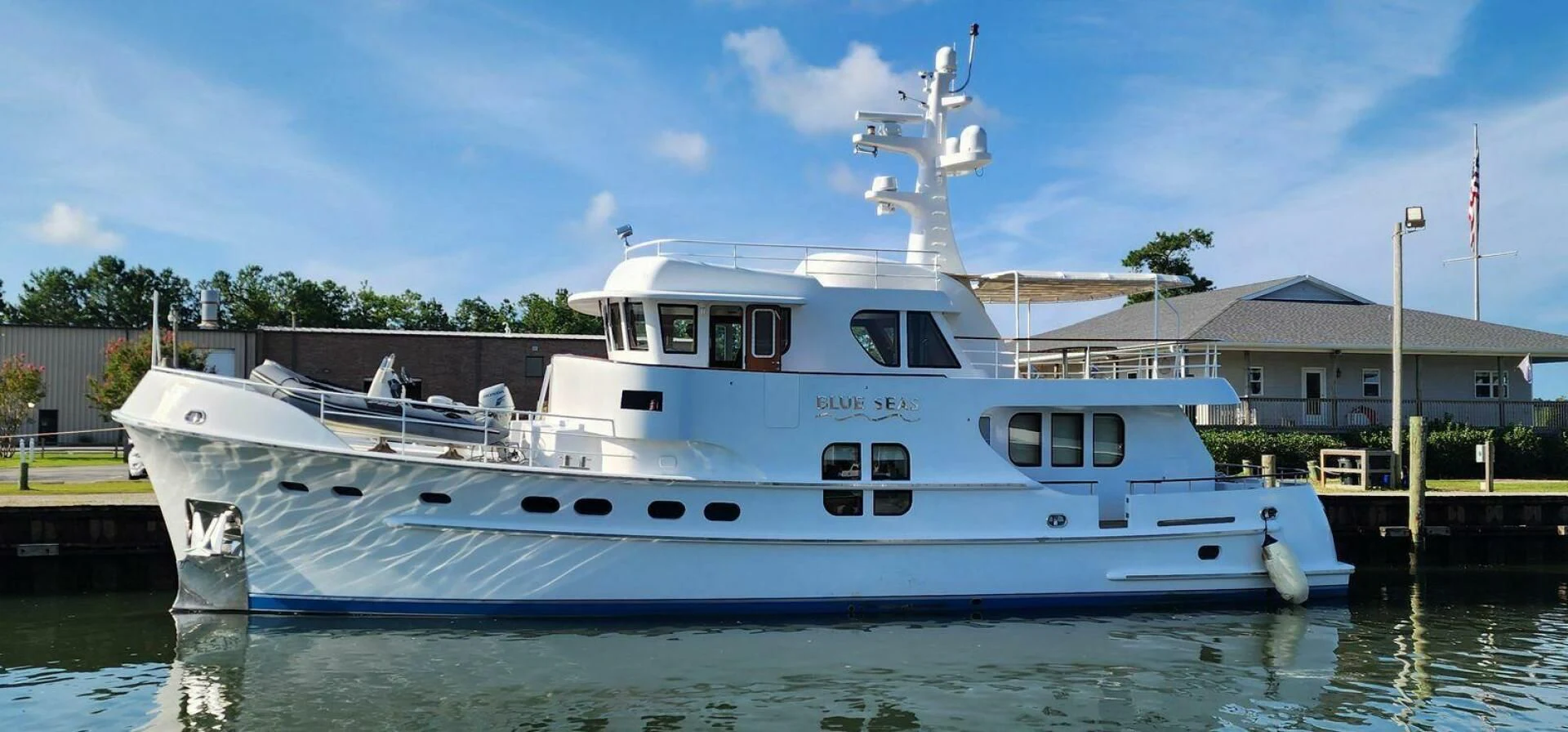 a white boat in a harbor aboard BLUE SEAS Yacht for Sale