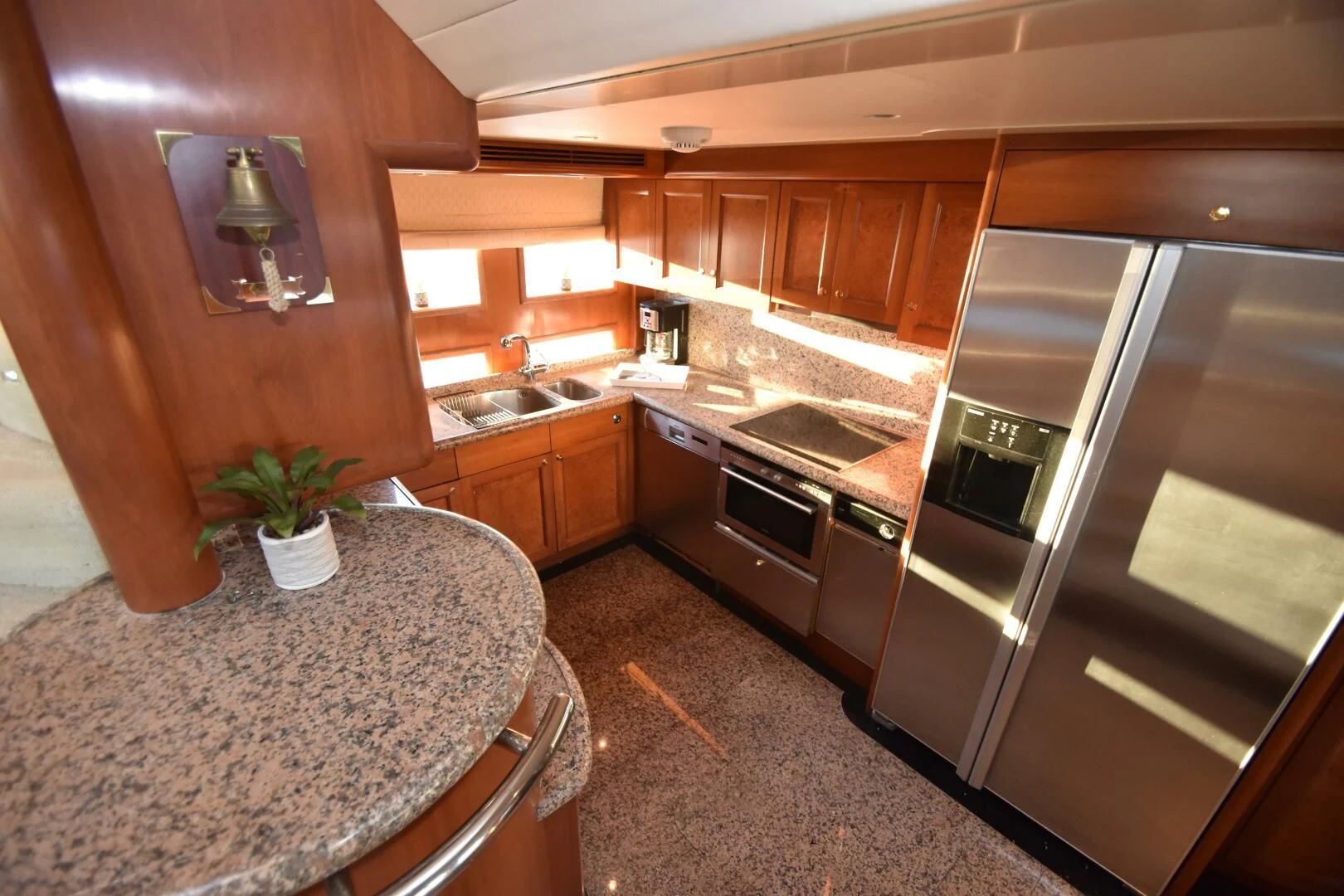 a kitchen with wooden cabinets aboard BLUE SEAS Yacht for Sale