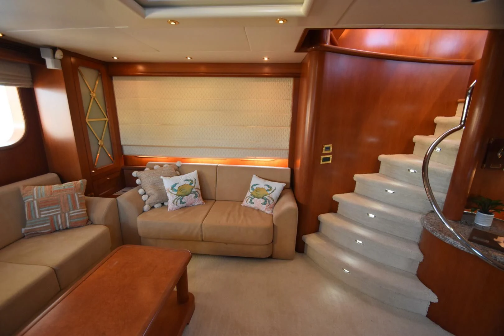 a living room with a couch and a staircase aboard BLUE SEAS Yacht for Sale