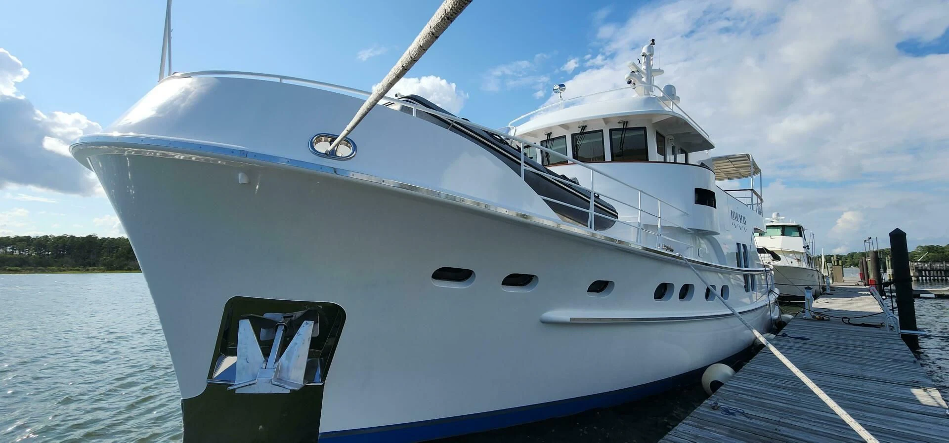 a white yacht docked at a dock aboard BLUE SEAS Yacht for Sale