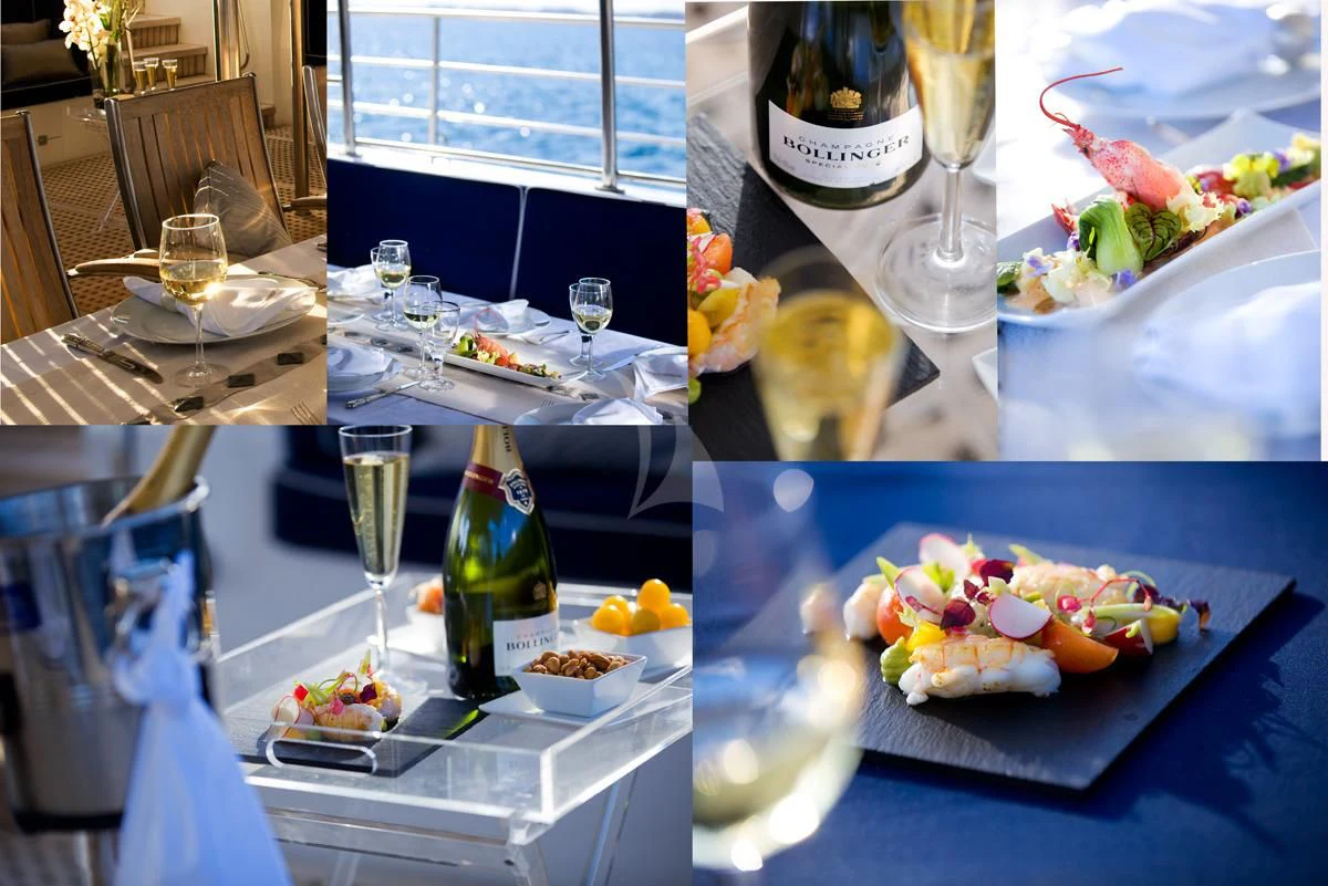 a table with food and wine aboard DWINGER Yacht for Sale