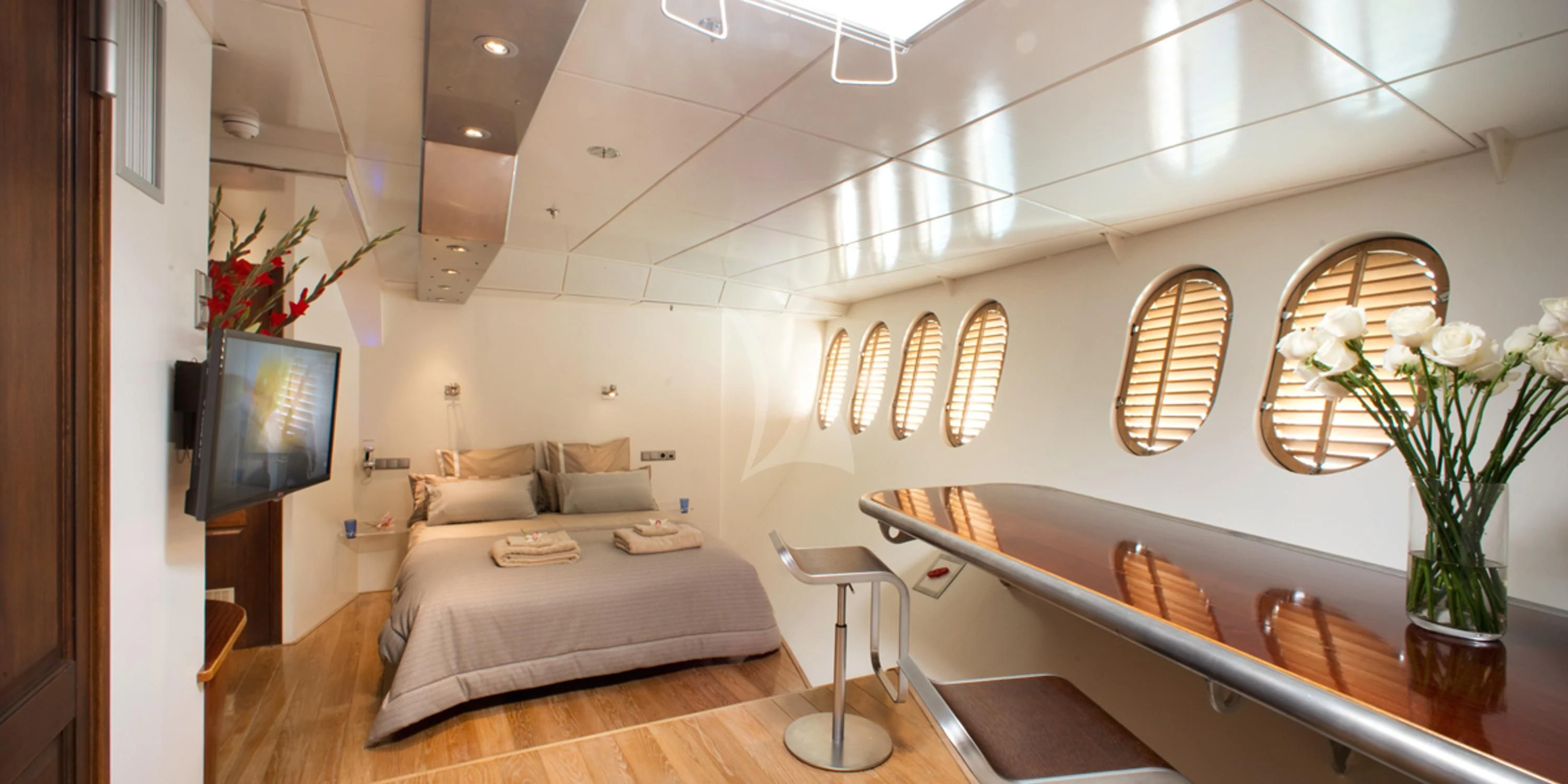 a room with a bed and a television aboard DWINGER Yacht for Sale