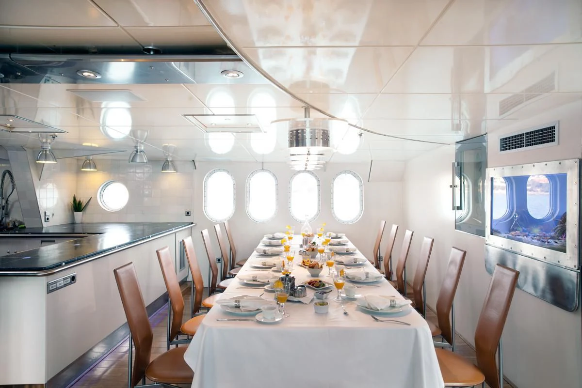 a dining room with tables and chairs aboard DWINGER Yacht for Sale