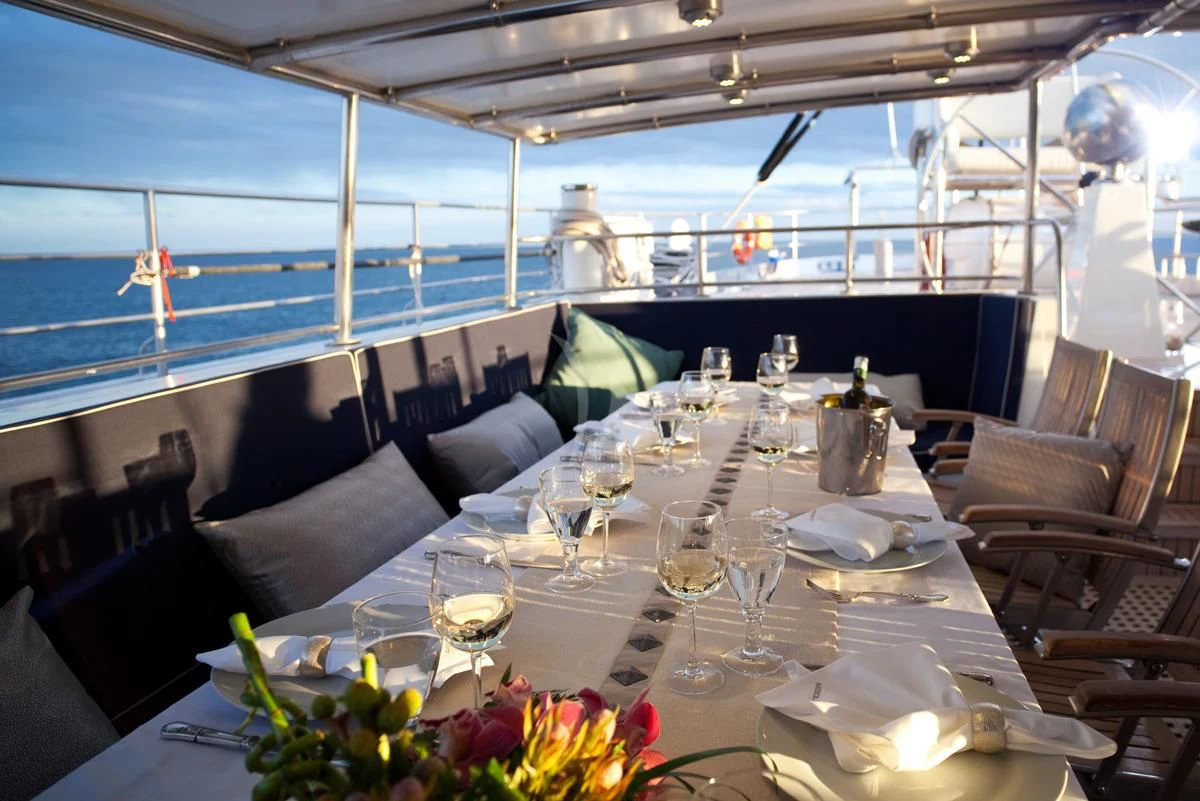 a table set for a dinner aboard DWINGER Yacht for Sale