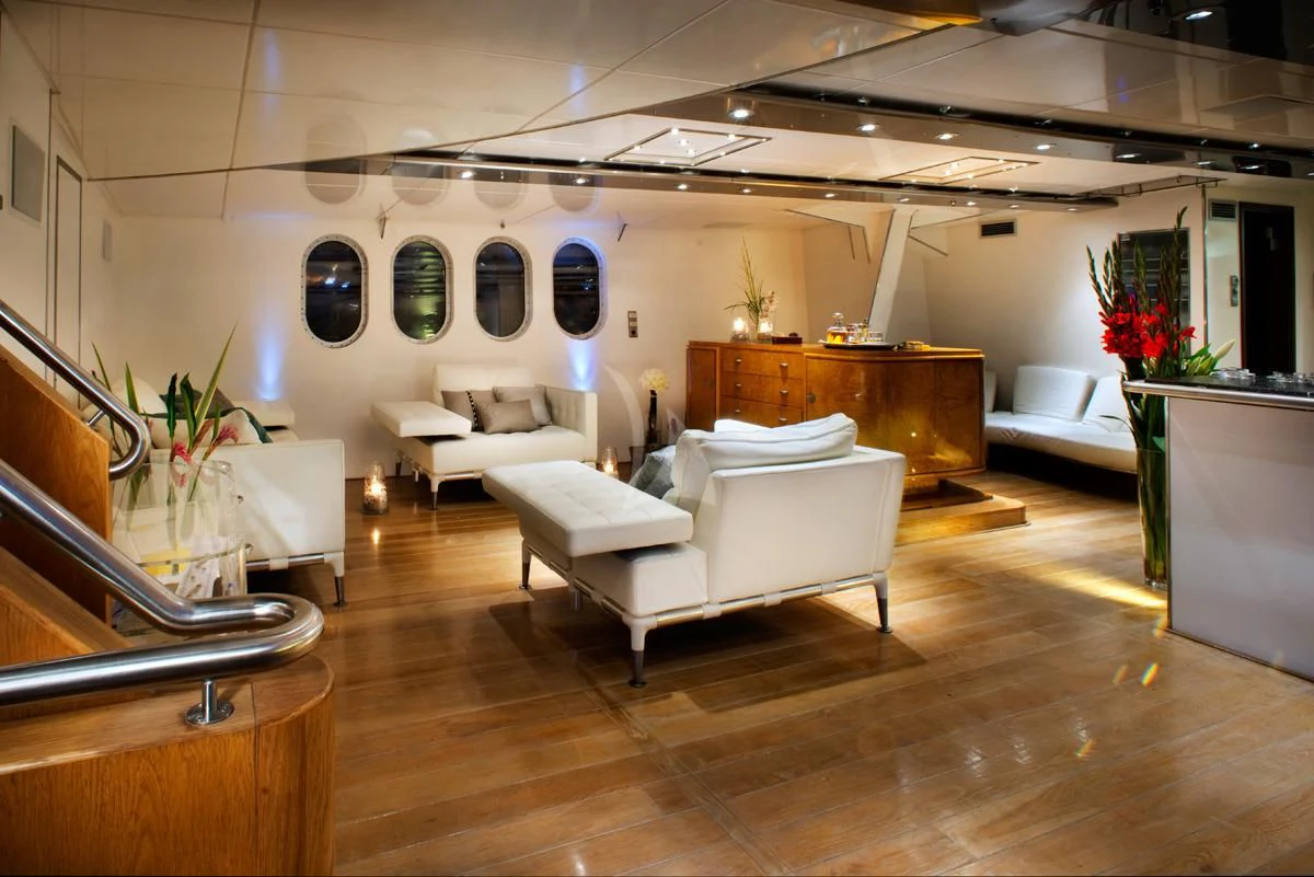 a room with a couch and a piano aboard DWINGER Yacht for Sale