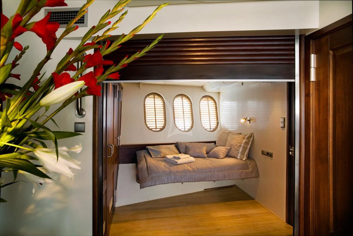 a room with a bed and a window aboard DWINGER Yacht for Sale