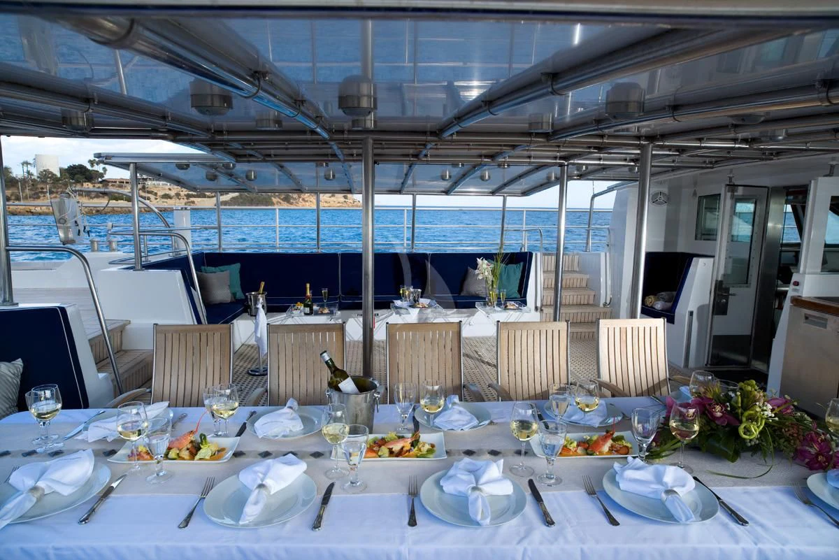 a table set for a dinner party aboard DWINGER Yacht for Sale