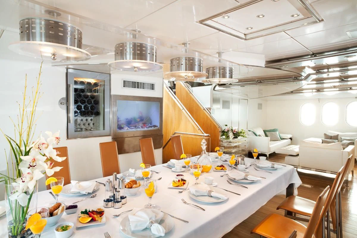 a dining room with tables and chairs aboard DWINGER Yacht for Sale