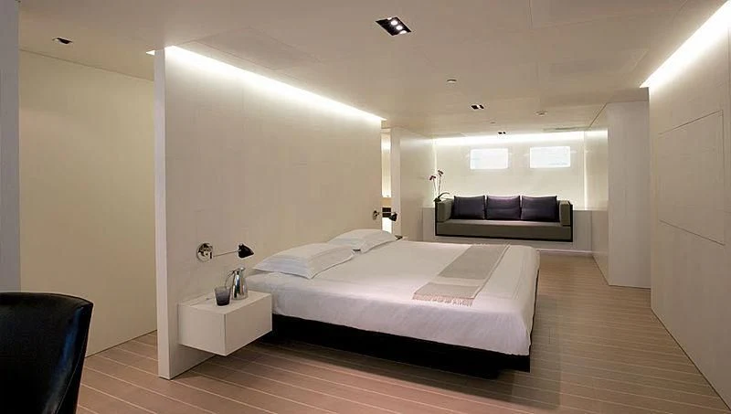 a room with a bed and a couch aboard BARACUDA VALLETTA Yacht for Sale